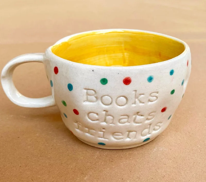 Vintage floral glass cups-Books chats friends wobby mug in yellow. These mugs are hand built so each mug will be different in its crookedness and wobbliness. No two are the same.