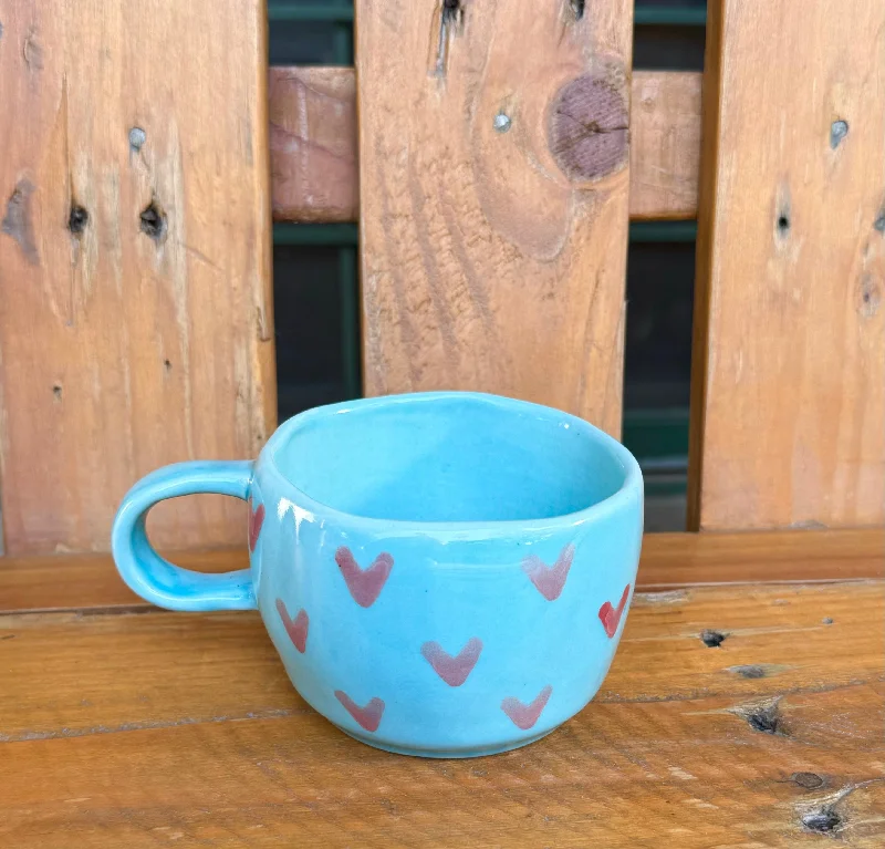 Artisan stoneware latte mugs-Light blue wobbly mug with tiny pink hearts.