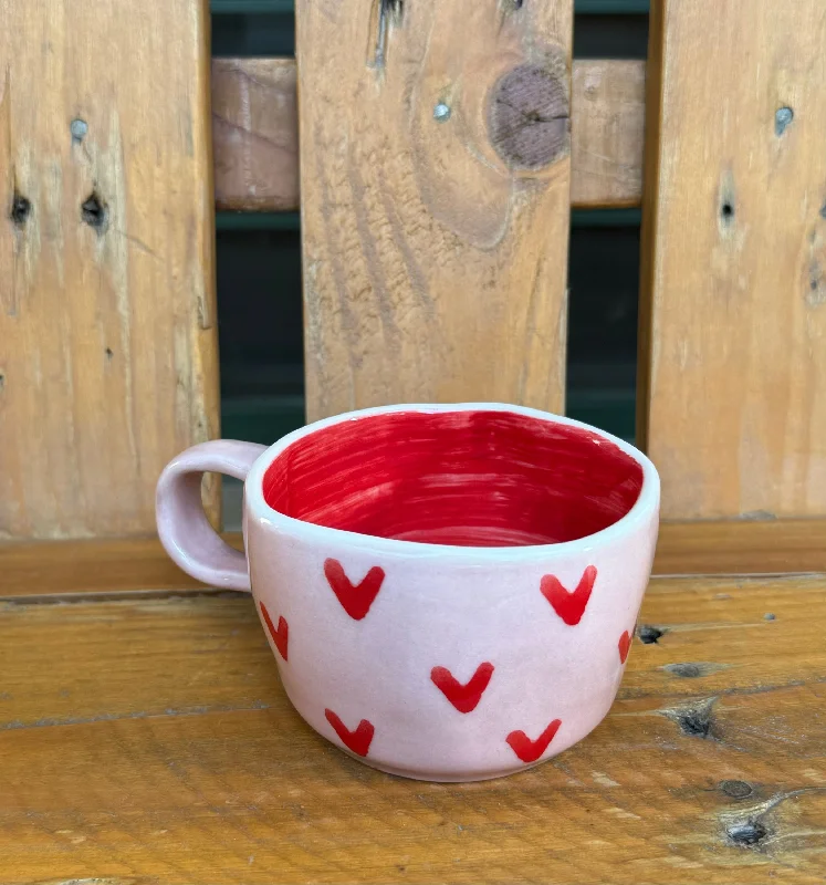 Hand-painted ceramic tumblers-Pink wobbly mug with tiny red hearts.