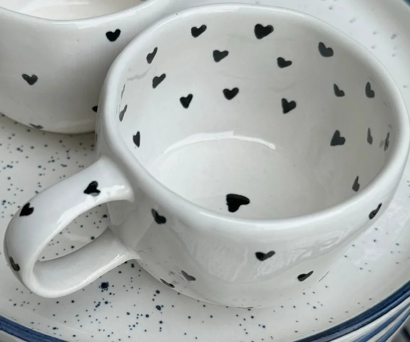 Quirky slogan coffee mugs-Tiny black hearts on cream wobbly mug.